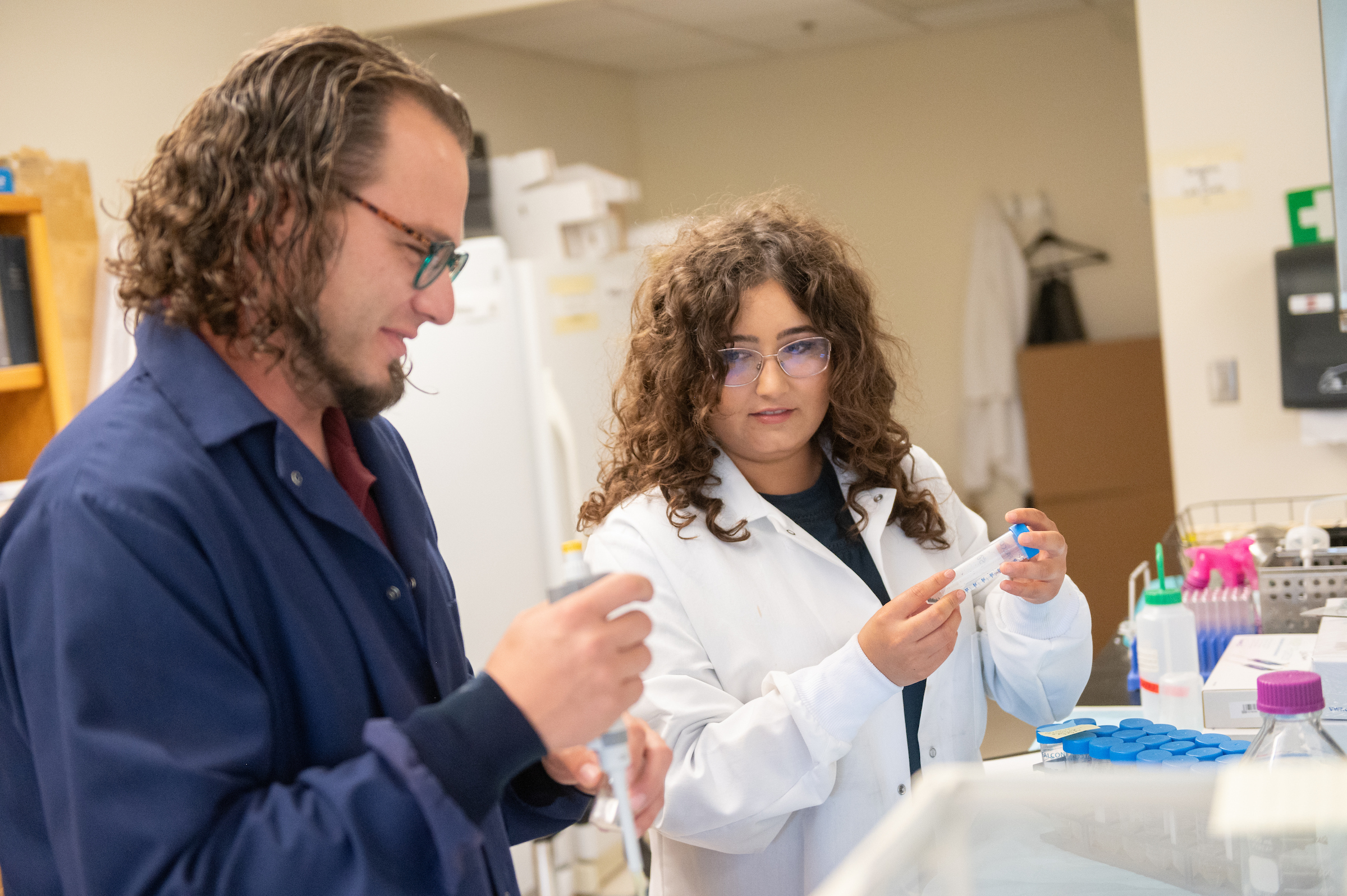 A man and a woman working in a science laboratory
